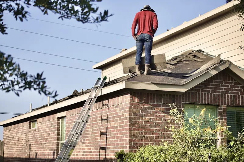 Professional roofer working on a residential roof in Bolsa Chica-Heil